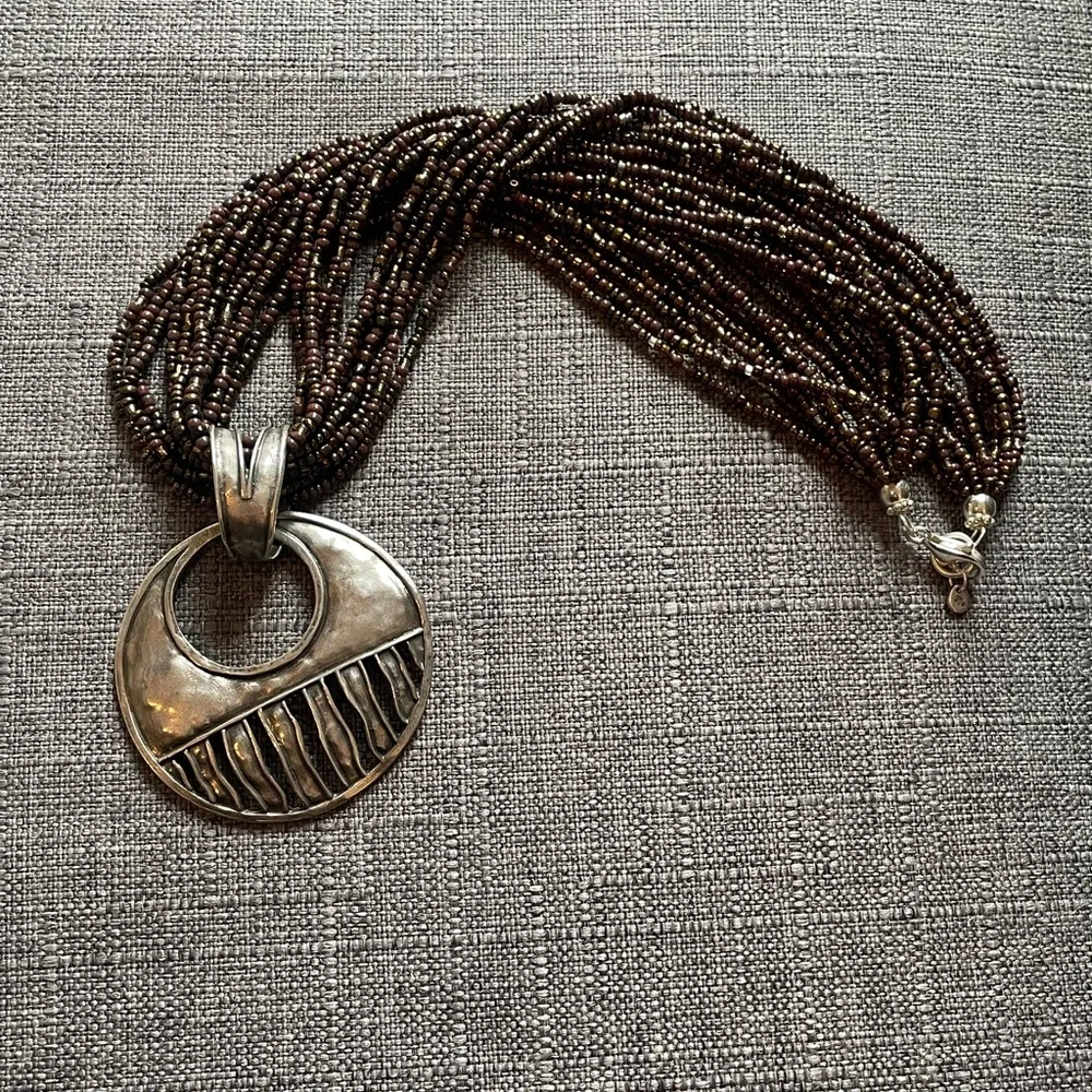 Make a statement with this twisted beaded necklace that has this unique pendant. - Picture 3 of 4